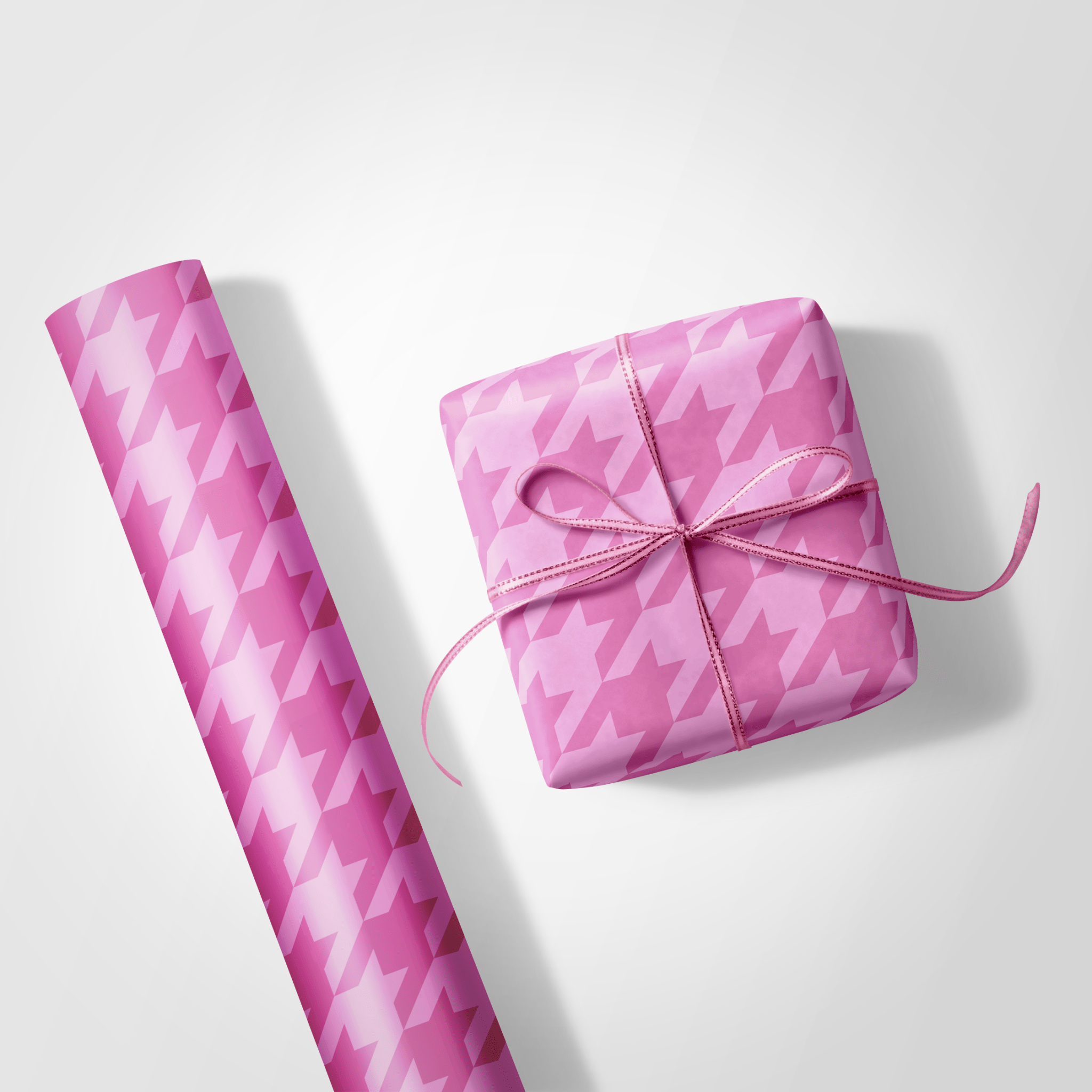 Pink houndstooth patterned gift wrap and a wrapped gift on a white background