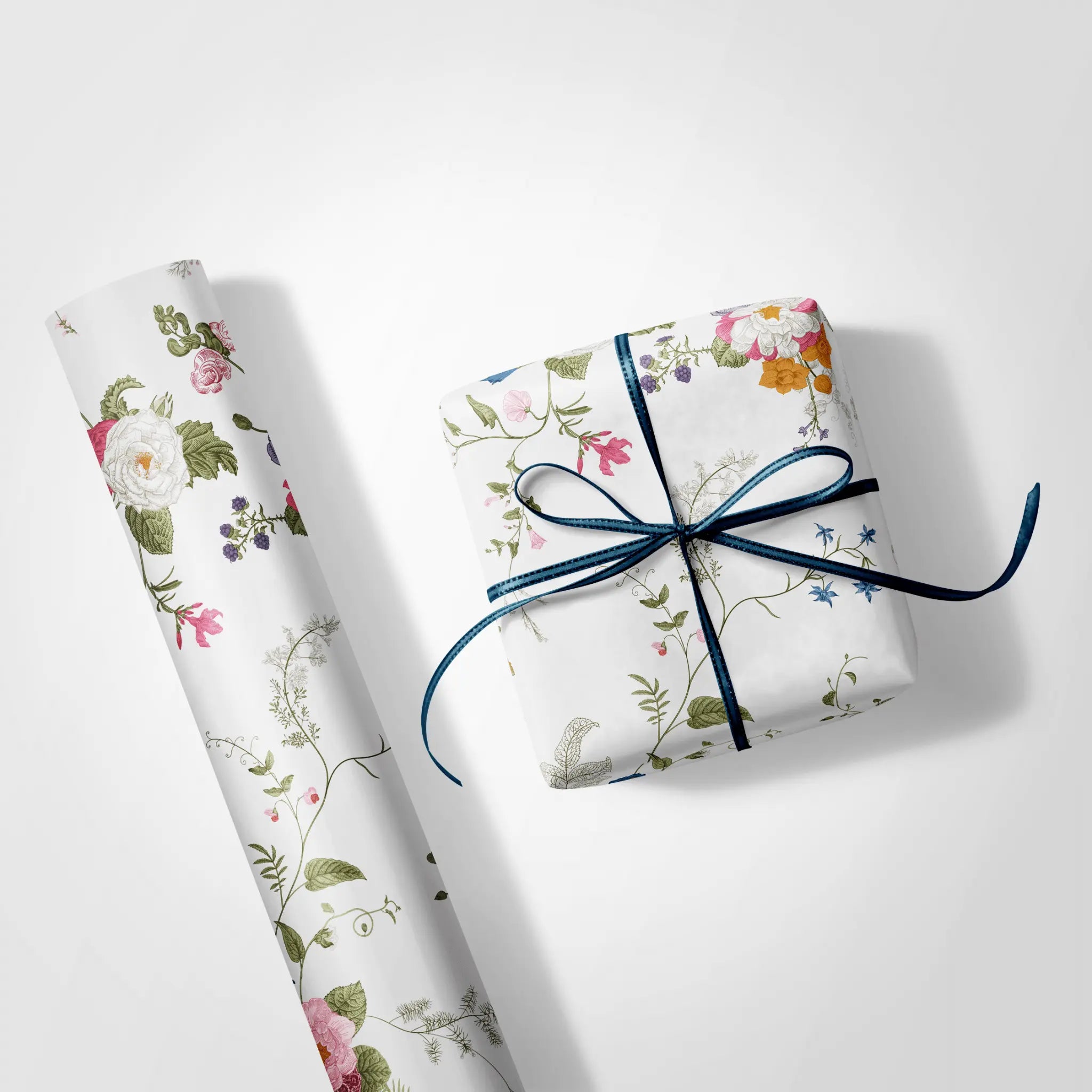 Haus of Wrap’s Flora Vine botanical gift wrap, perfect for weddings, birthdays, or holiday gifts, with luxe blue ribbon.