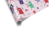 Light pink wrapping paper with a scattered pattern of colorful cartoon dogs in party hats holding cakes and gifts, ideal for dog birthday wrapping paper.