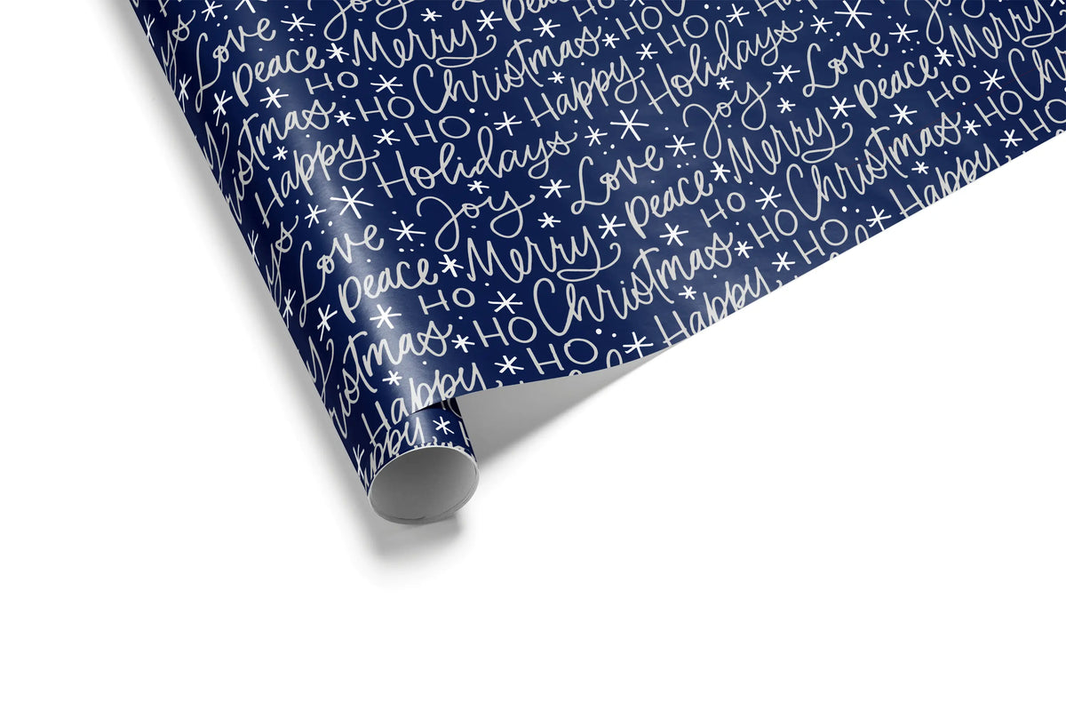 Haus of Wrap’s elegant navy gift wrap features festive white script—perfect holiday, birthday, or wedding wrapping paper.