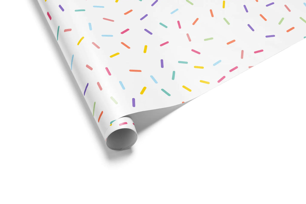 Birthday Gift Wrap Confetti Sprinkle wrapping paper roll with pastel rainbow sprinkles on white background