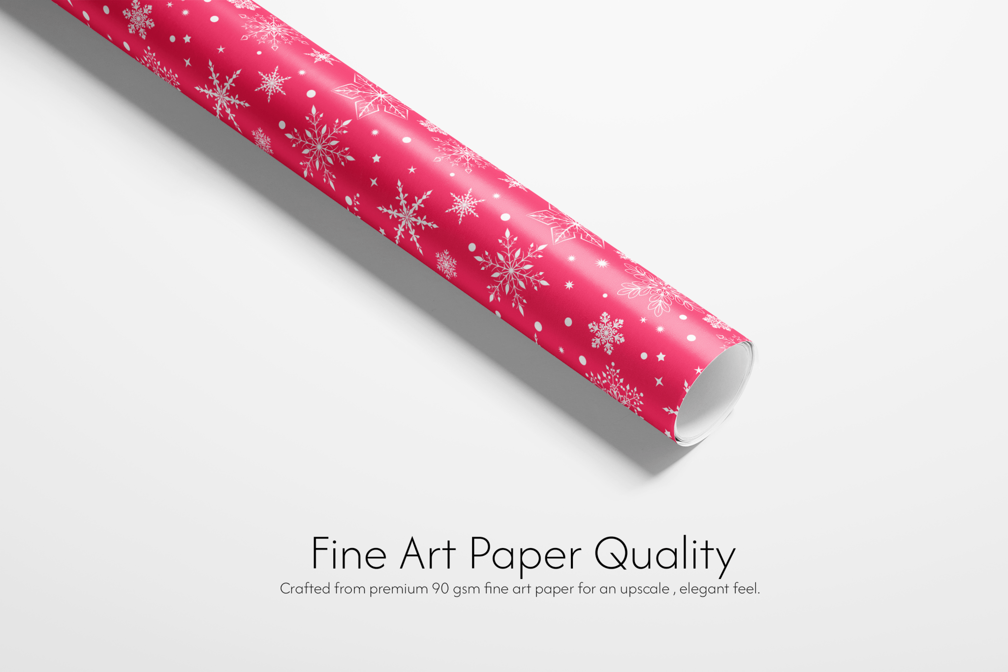 Roll of pink paper with snowflake pattern on a white background