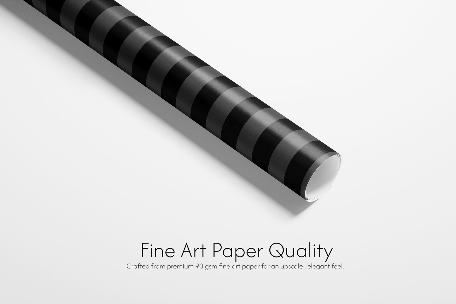 Roll of black and white striped paper with text about fine art paper quality on a light gray background