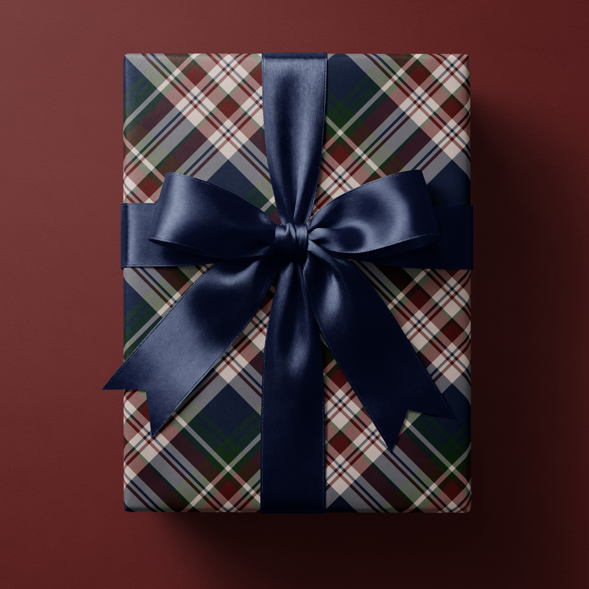 Heritage tartan Christmas wrapping paper in navy, burgundy, forest green and cream, set on the bias with fine overcheck lines.