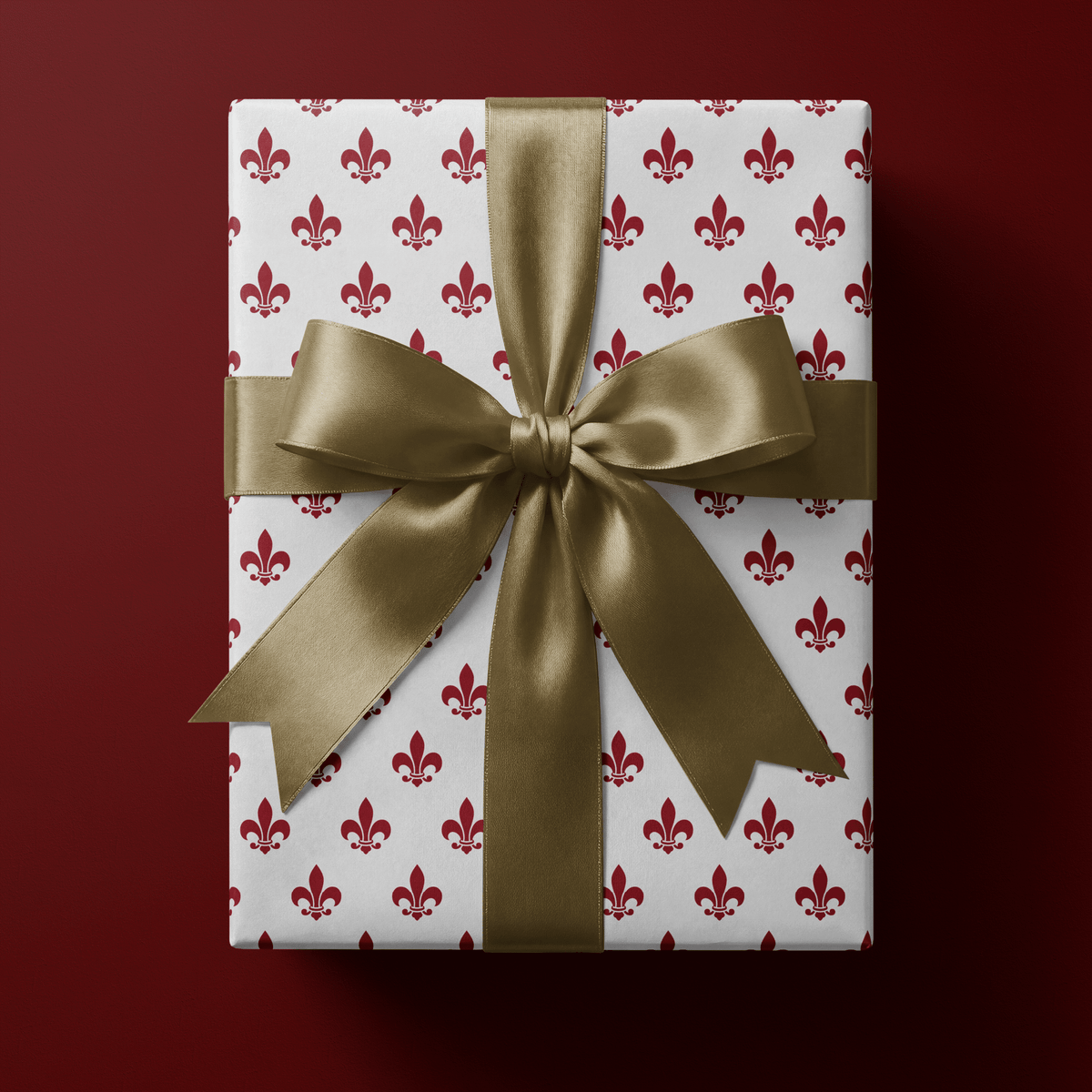 French wrapping paper with a deep crimson fleur-de-lis motif repeated evenly on white.