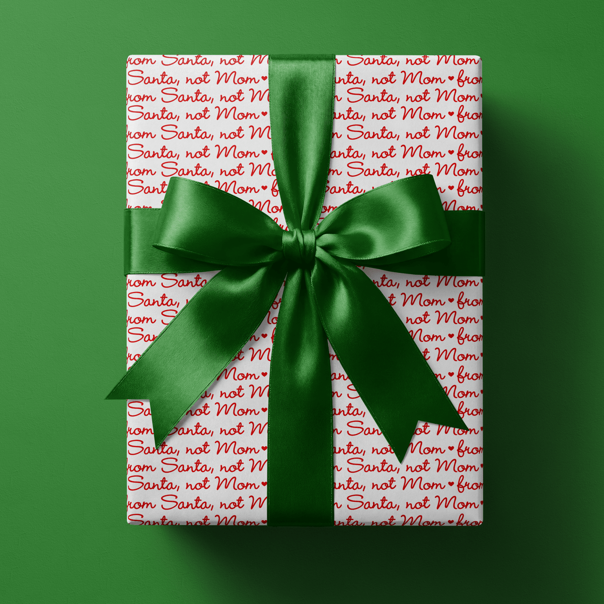 Wrapping paper from Santa in playful red script on white — the easiest way to keep gifts "from Santa" convincing, right down to the paper.