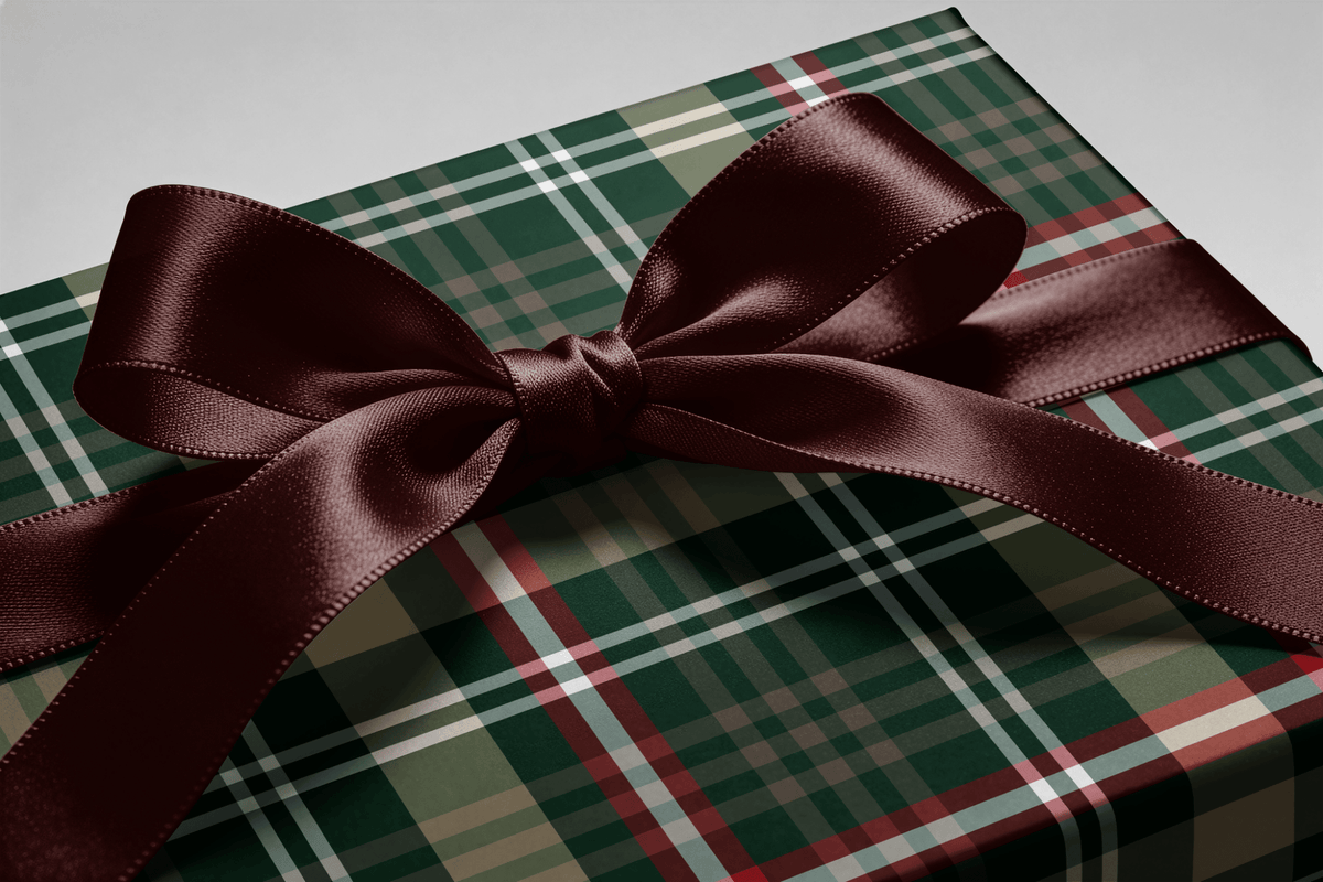 Close-up of the ribbon bow on a gift wrapped in Evergreen Tradition tartan wrapping paper