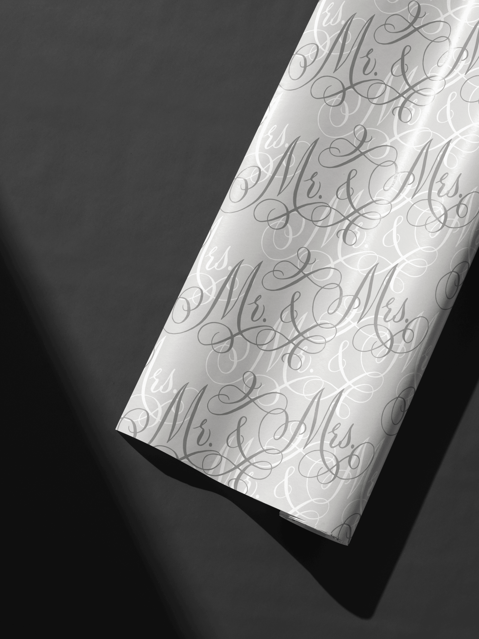 Wedding Wrapping Paper roll with layered Mr. & Mrs. calligraphy script on soft neutral background, luxe wedding gift wrap