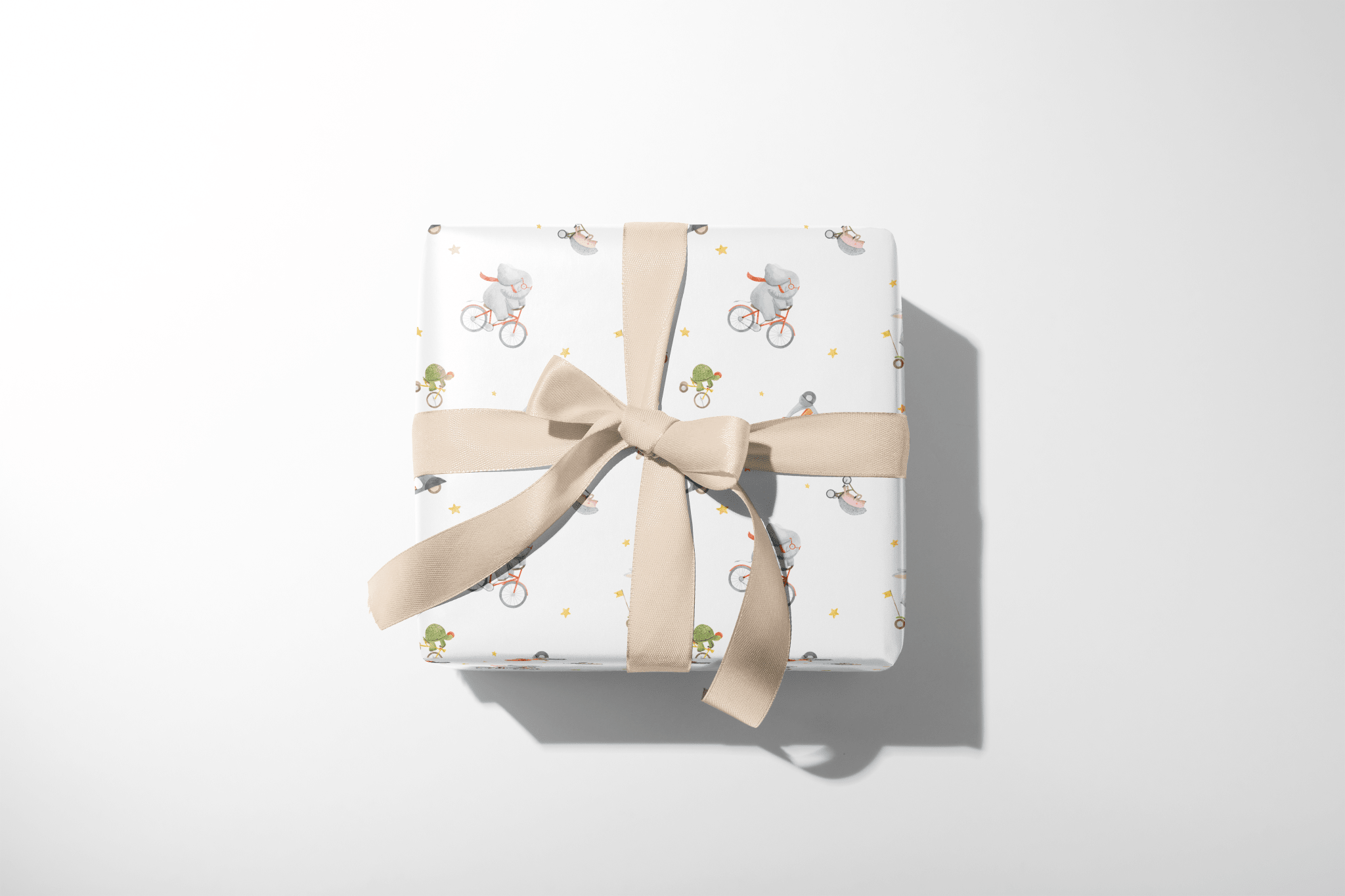 Alt Tag: Wild Wheels Adventure Wrap gift wrapping paper with safari animals on bicycles, wrapped present with beige ribbon