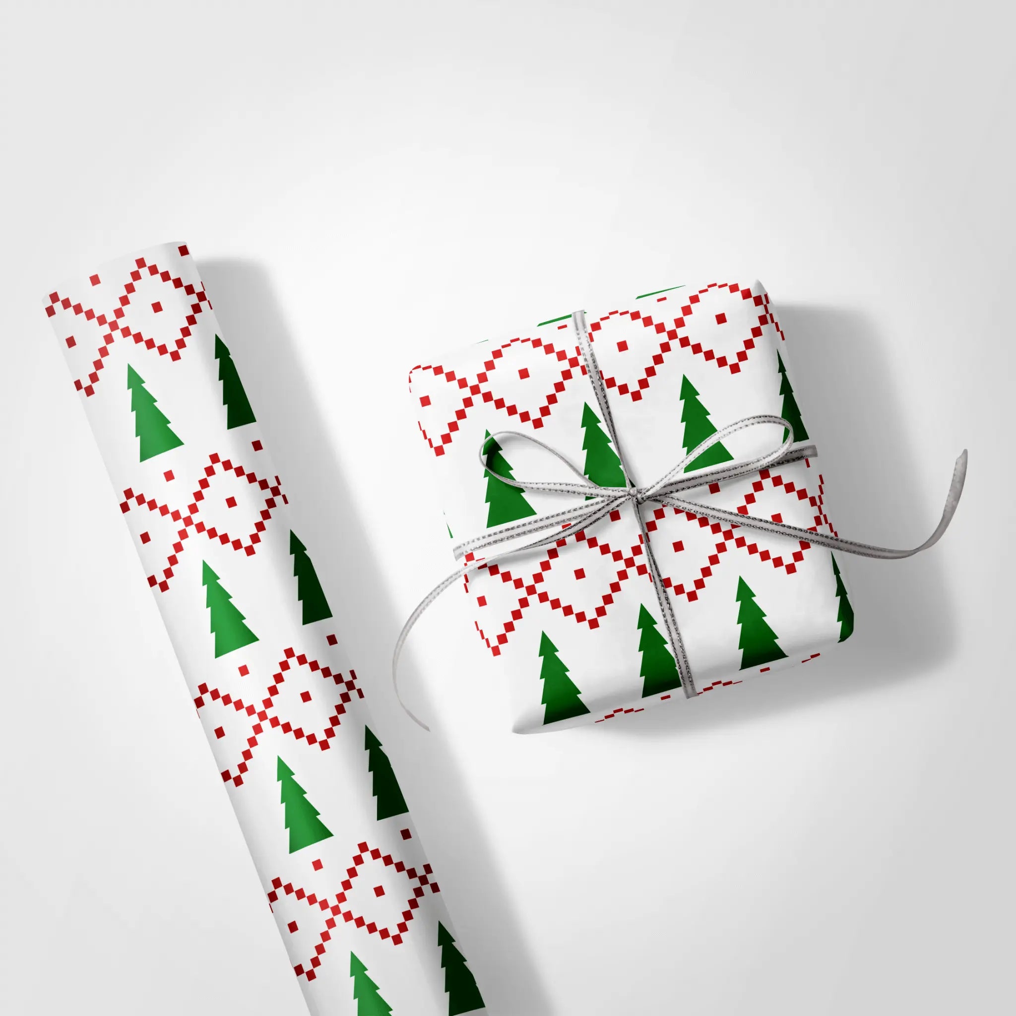 Ugly Sweater Wrapping Paper with red knit-style pattern and green Christmas trees, gift wrap roll and wrapped present on white