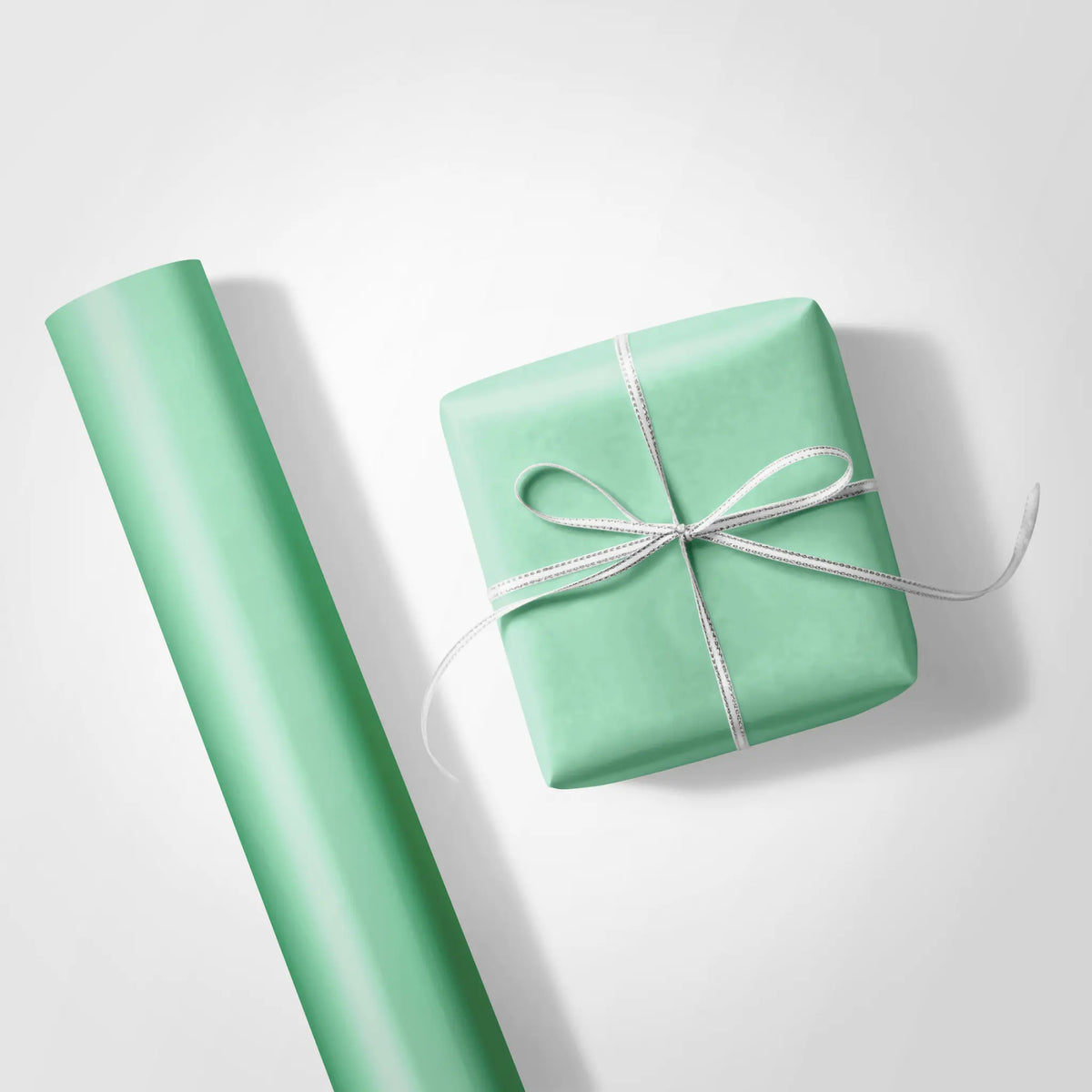 Solid mint green wrapping paper swatch, ideal for solid color wrapping paper and creating a calm, foundational look for gifts.