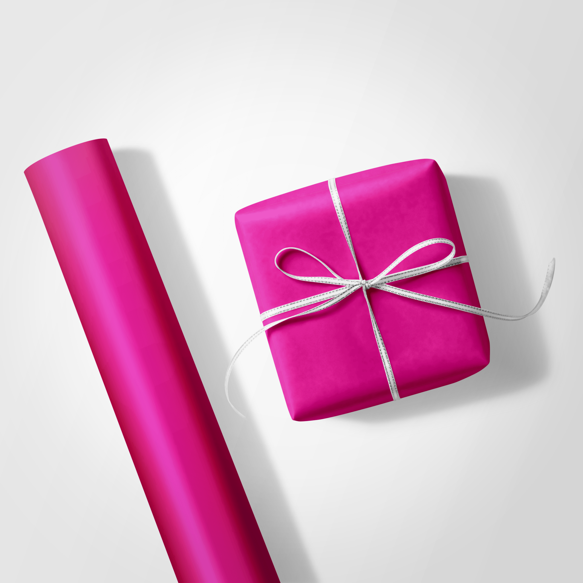 Pink gift wrap and a wrapped present on a white background