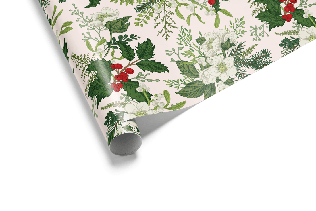Light pink Christmas wrapping paper with a detailed hand-drawn pattern of green holly leaves, red holly berries, pine needles, and white winter flowers.