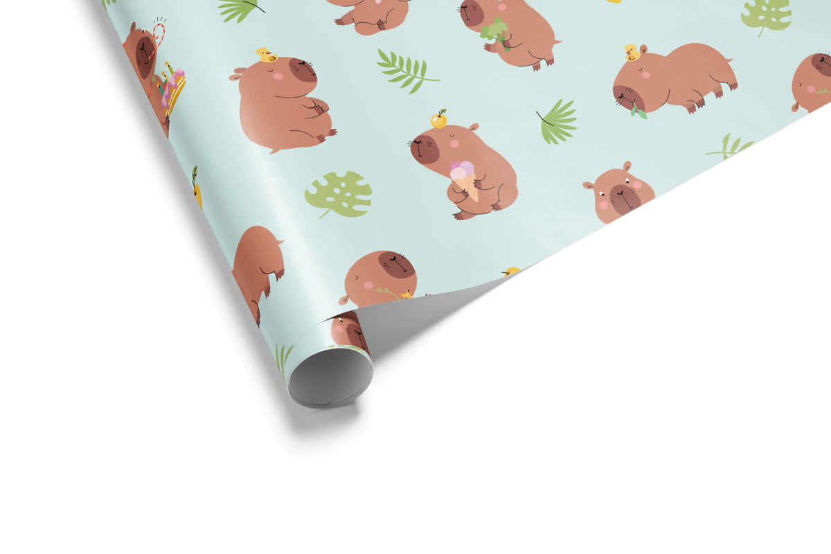 Alt Tag: Cute Birthday Wrapping Paper with cerulean blue capybara pattern and green botanicals on gift wrap roll