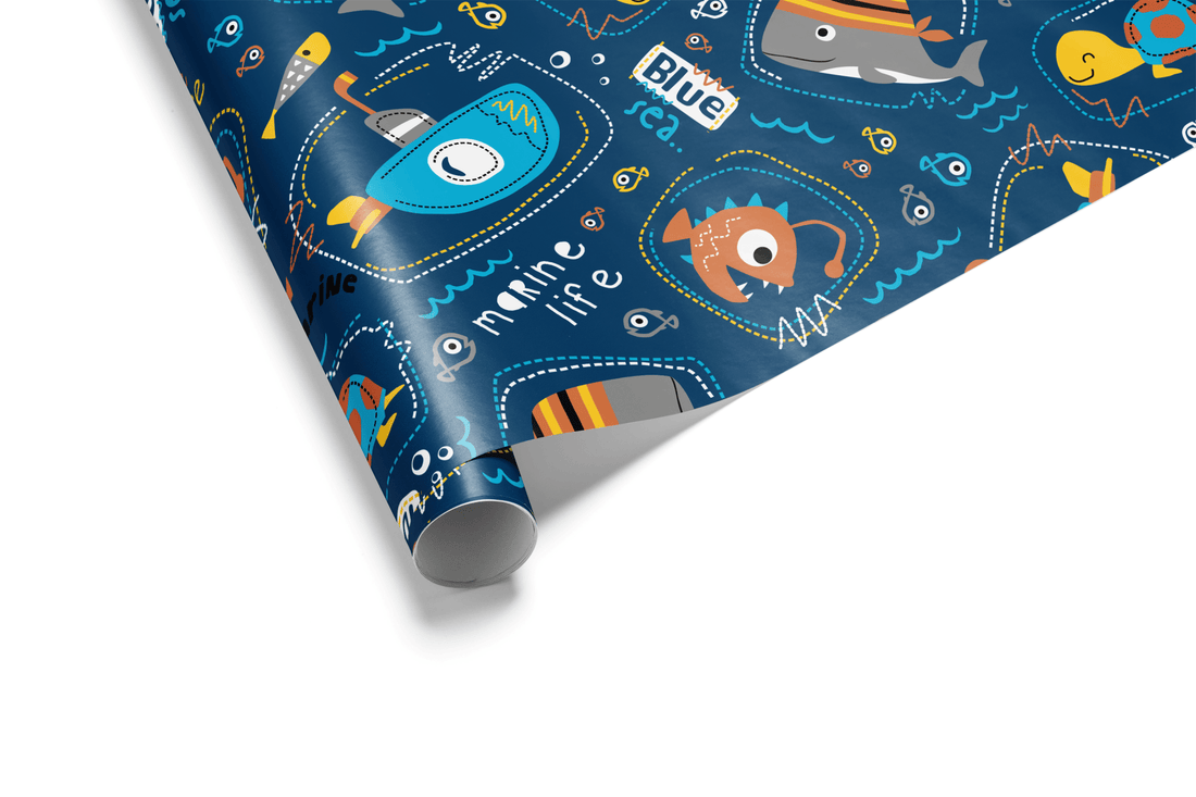 Deep navy blue wrapping paper with a cartoon pattern of submarines, whales, turtles, and unique fish, ideal for ocean and boy birthday wrapping paper.