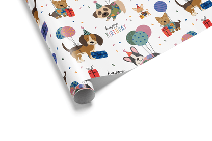 White birthday wrapping paper with a scattered pattern of colorful cartoon puppies of various breeds, party hats, balloons, and small gifts.
