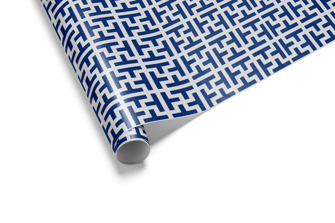 High-contrast geometric wrapping paper with a repeating fretwork or maze pattern in deep navy blue and light gray, ideal for mens wrapping paper and modern gifts.
