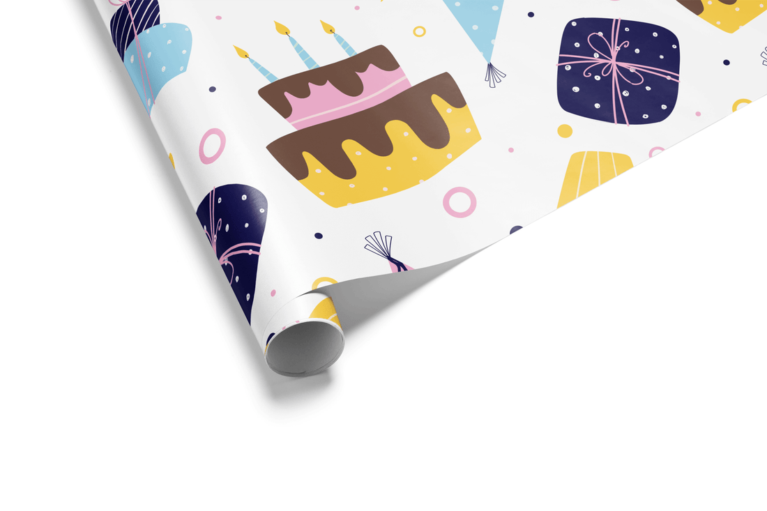 White wrapping paper with a scattered pattern of colorful birthday cakes with candles, party hats, and wrapped presents in shades of blue, pink, and yellow.