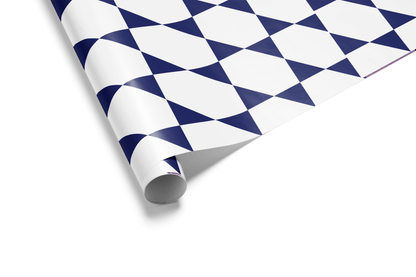 White wrapping paper with a geometric pattern of interlocking deep navy blue and white triangles, forming a stylized Star of David for Hanukkah wrapping paper.