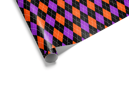 Dense halloween wrapping paper with an Argyle (diamond) pattern in high-contrast black, vivid orange, and purple, accented with fine white dashed lines.