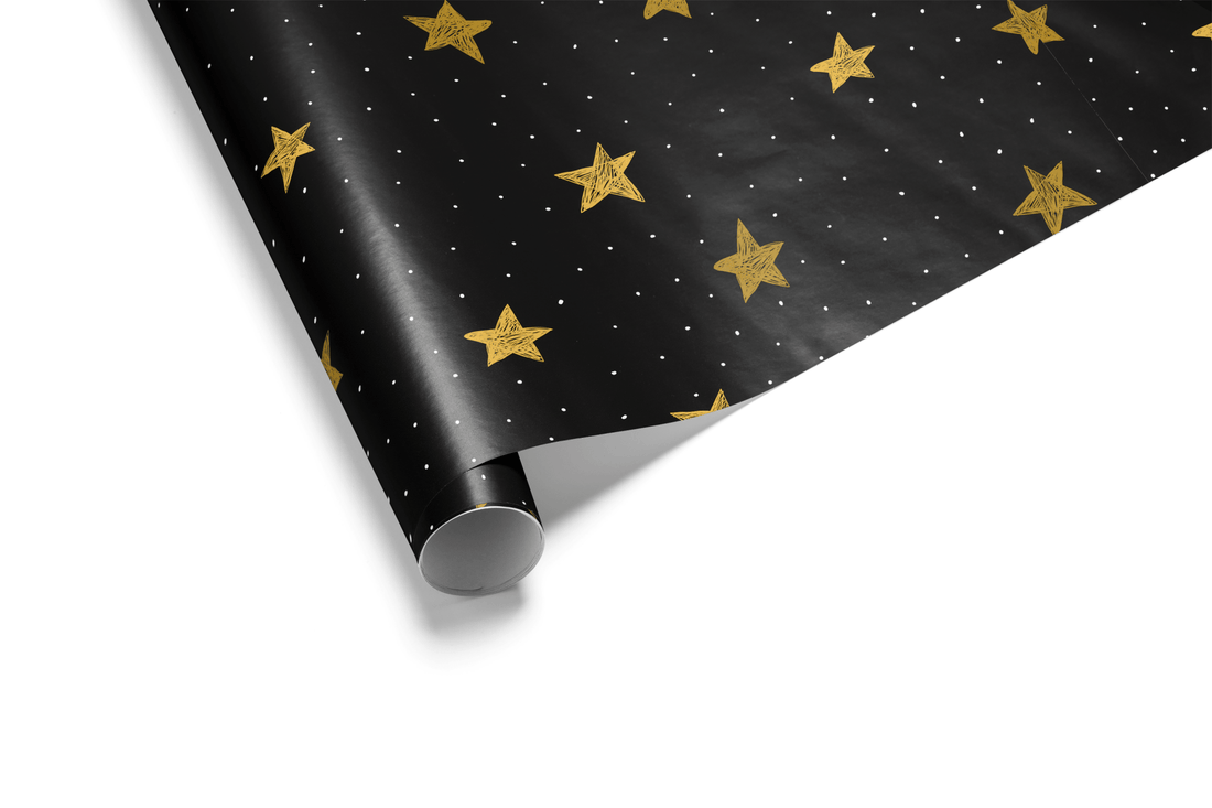 Solid black wrapping paper with a scattered pattern of hand-drawn, metallic gold stars and small white dots, ideal for black and gold luxury gift wrap.