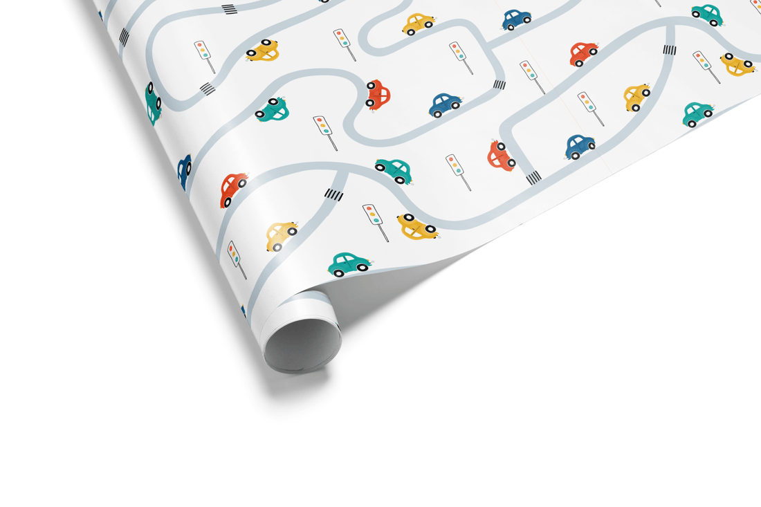 White wrapping paper with a scattered pattern of small, colorful cartoon cars (red, blue, yellow) driving on a winding gray road pattern, ideal for boy birthday wrapping paper.