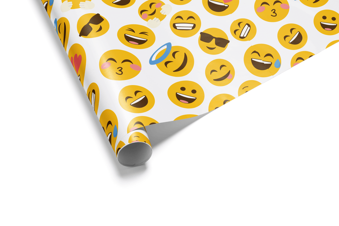 White wrapping paper with a dense, colorful pattern of various yellow emoji faces, including the kissing face and heart-eye emoji, ideal for birthday gifts.