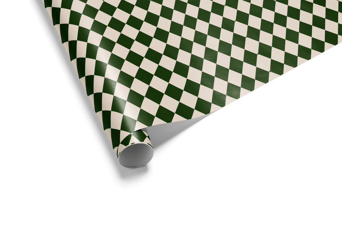Diamond checkerboard wrapping paper (Harlequin pattern) in high-contrast deep forest green and light cream, ideal for mens wrapping paper and geometric wrapping paper.