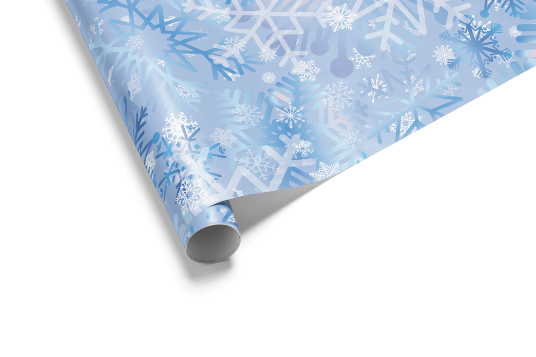 Christmas wrapping paper with an artistic, multi-layered pattern of watercolor snowflakes in shades of blue, lavender, and white, ideal for winter wonderland themes.