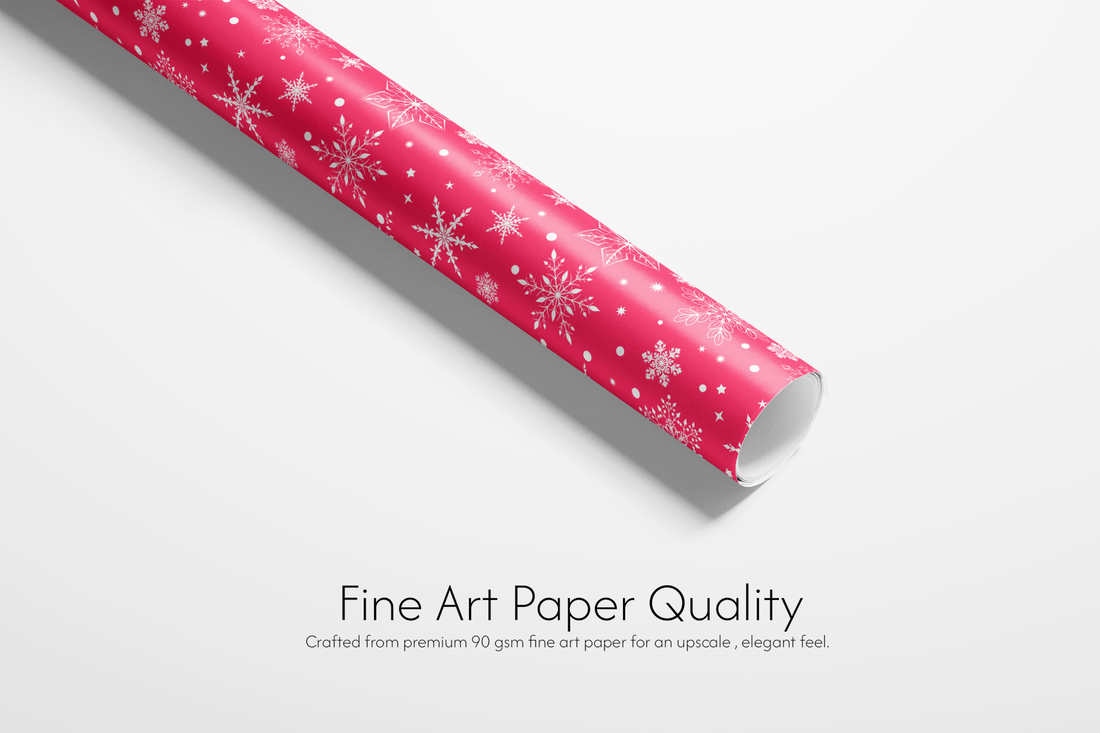 Roll of pink paper with snowflake pattern on a white background