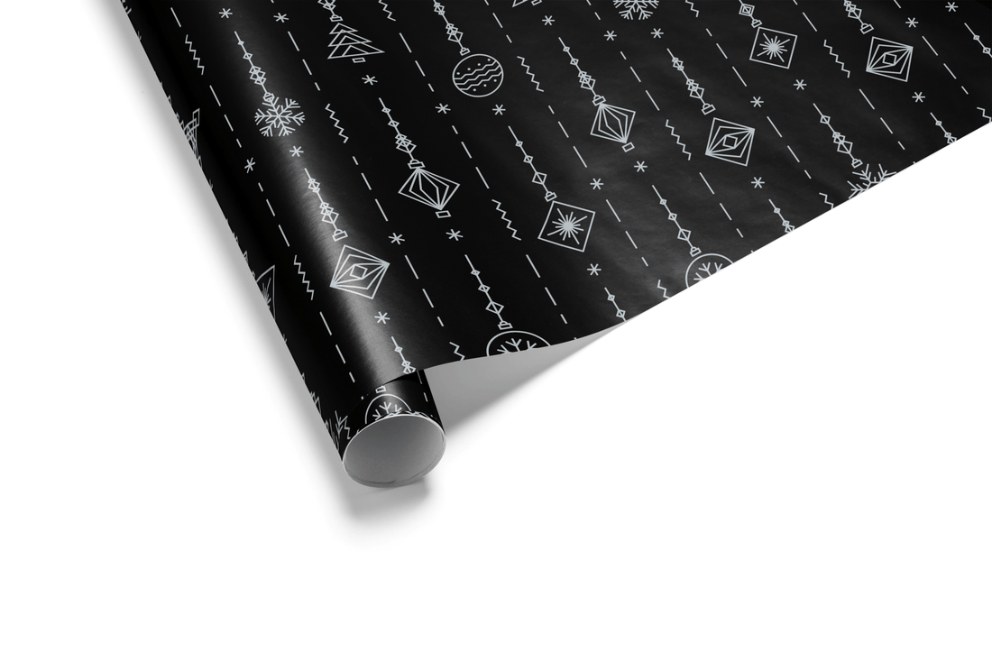 Solid black Christmas wrapping paper with a dense, vertical striped pattern made of small silver ornaments, snowflakes, and geometric shapes, ideal for black and silver luxury wrap.