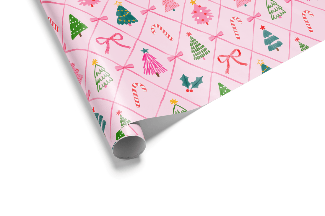 Pink Christmas wrapping paper with festive trees, bows, candy canes, and holly.