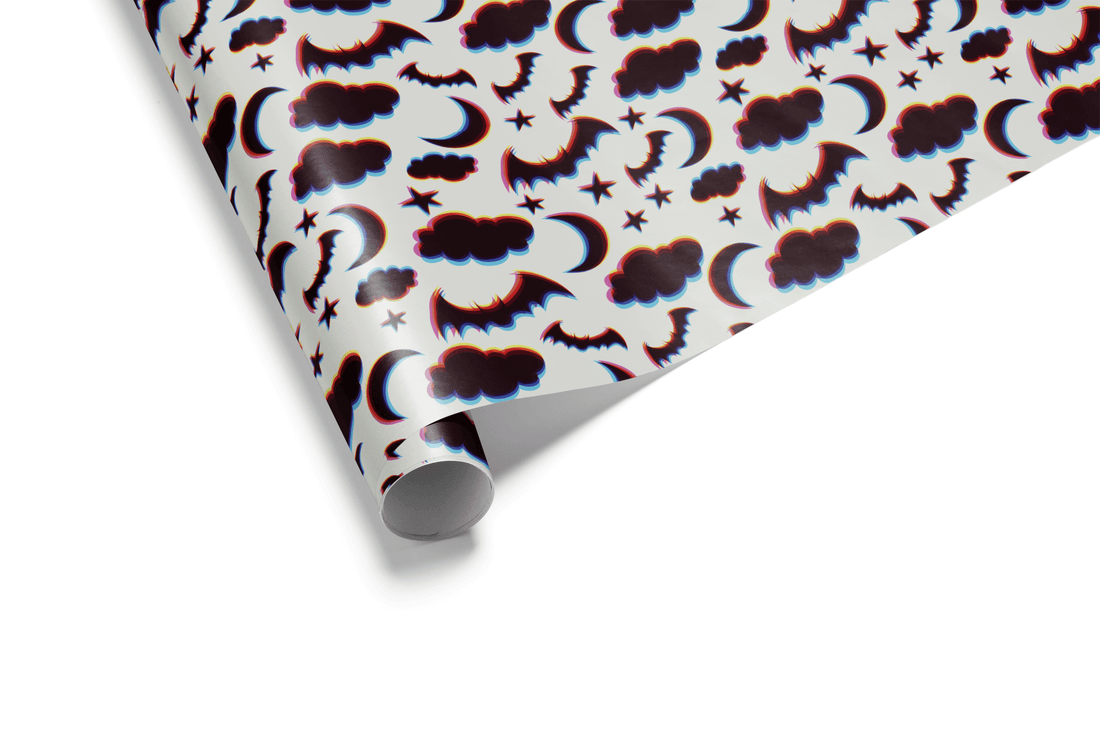 Halloween wrapping paper with bats, moons, clouds, and stars on a white background.
