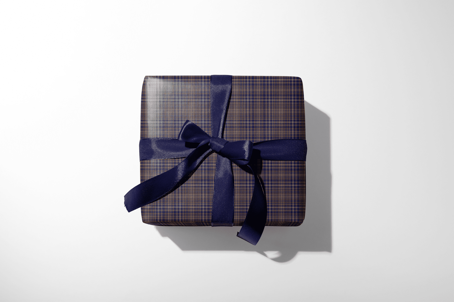 Gift box with plaid pattern and blue ribbon on a white background