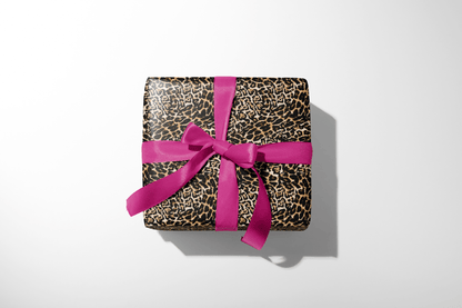 Leopard print gift box with a pink ribbon on a white background