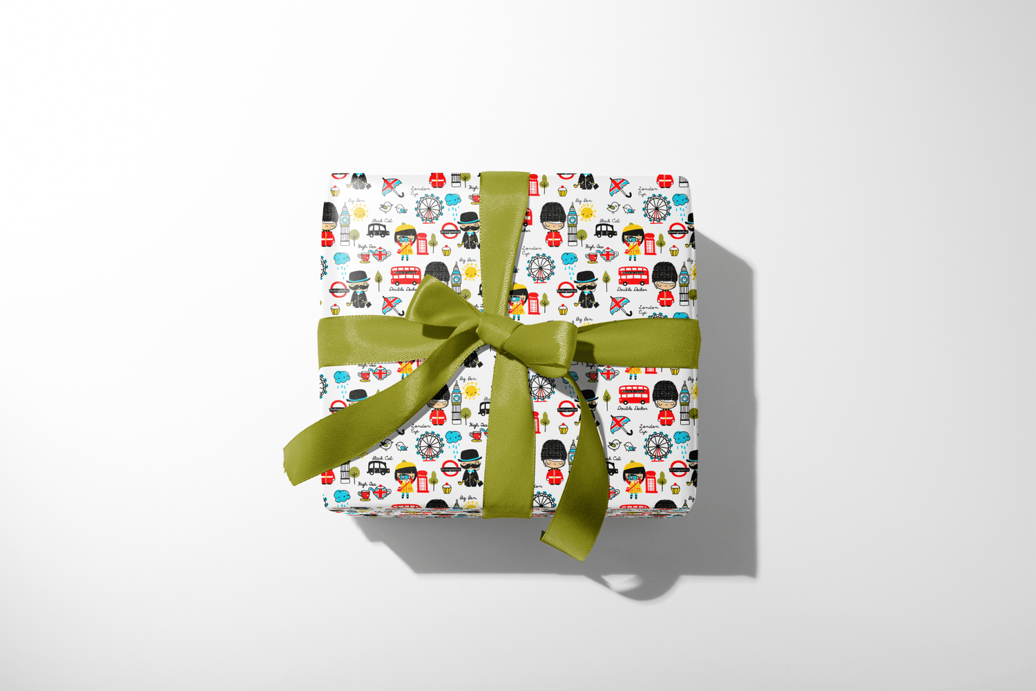 Gift box with colorful pattern and green ribbon on a white background