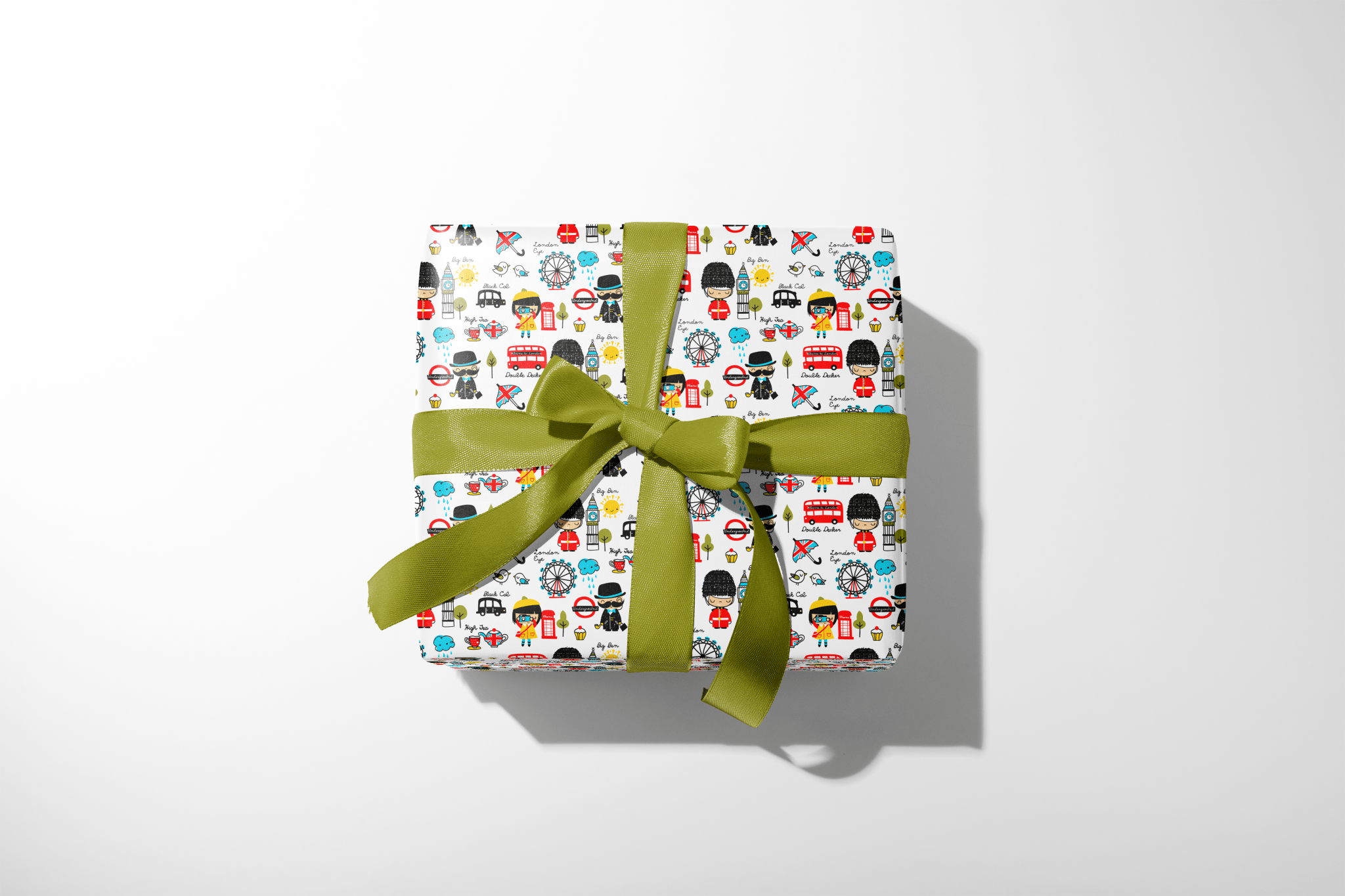 Gift box with colorful pattern and green ribbon on a white background