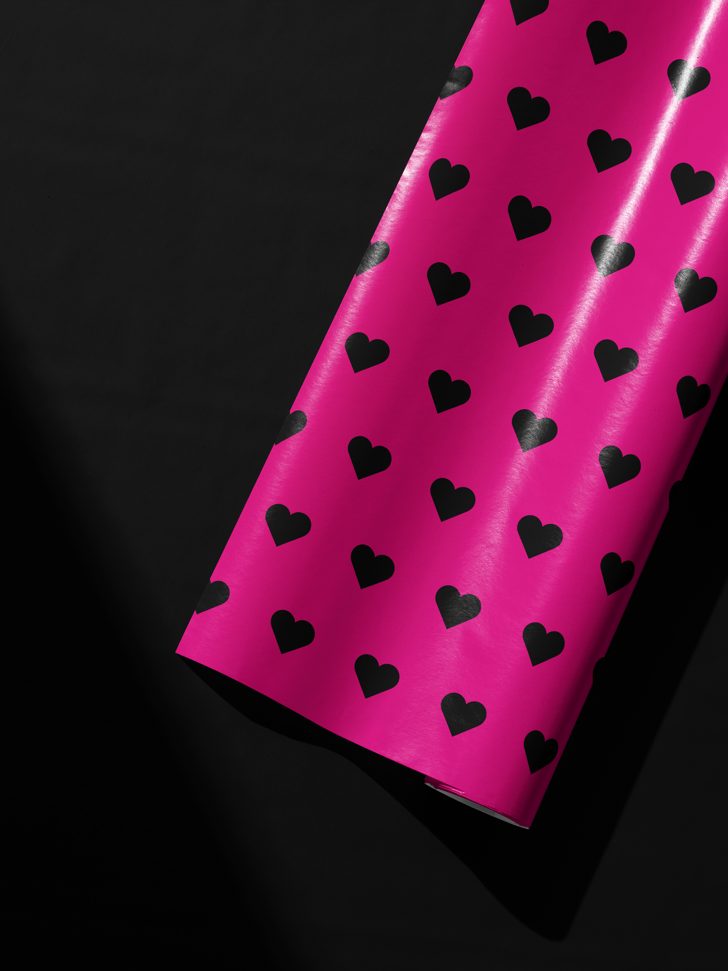 Alt Tag: Pink Heart Wrapping Paper roll in hot pink with black heart pattern, bold modern gift wrap for confident celebrations