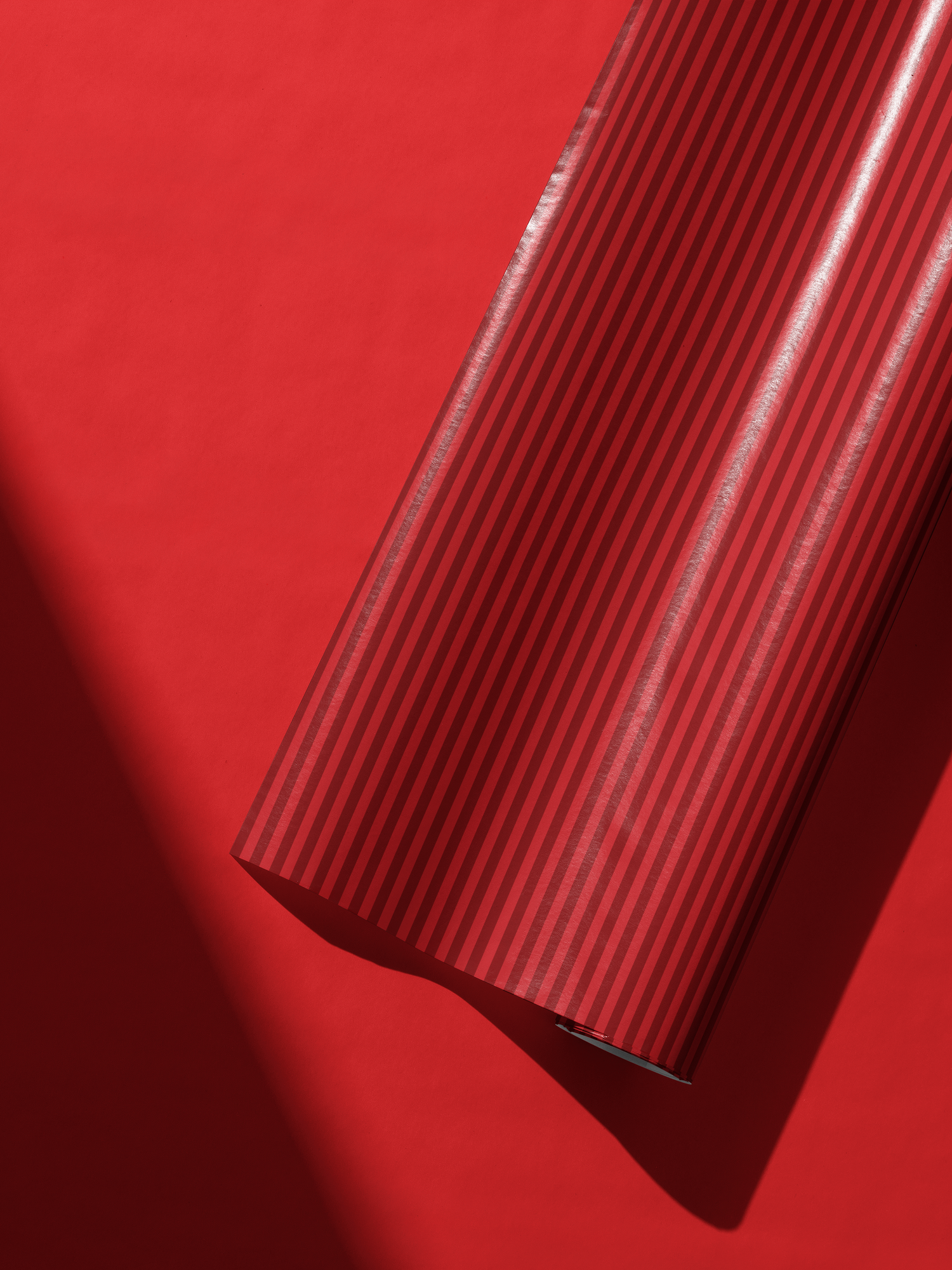 Alt Tag: Red Stripe Wrapping Paper roll with vertical scarlet stripes on red background, tailored polished gift wrap