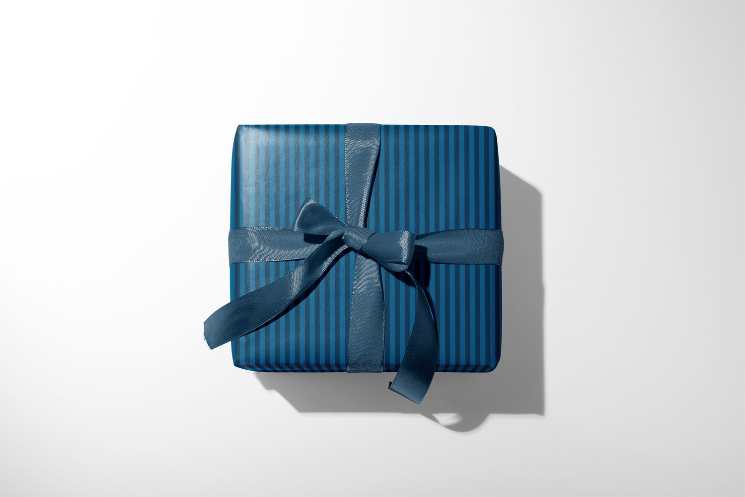 Alt Tag: Teal Stripe Wrapping Paper on gift box with dark teal vertical stripes and satin ribbon bow, Midnight Tailor