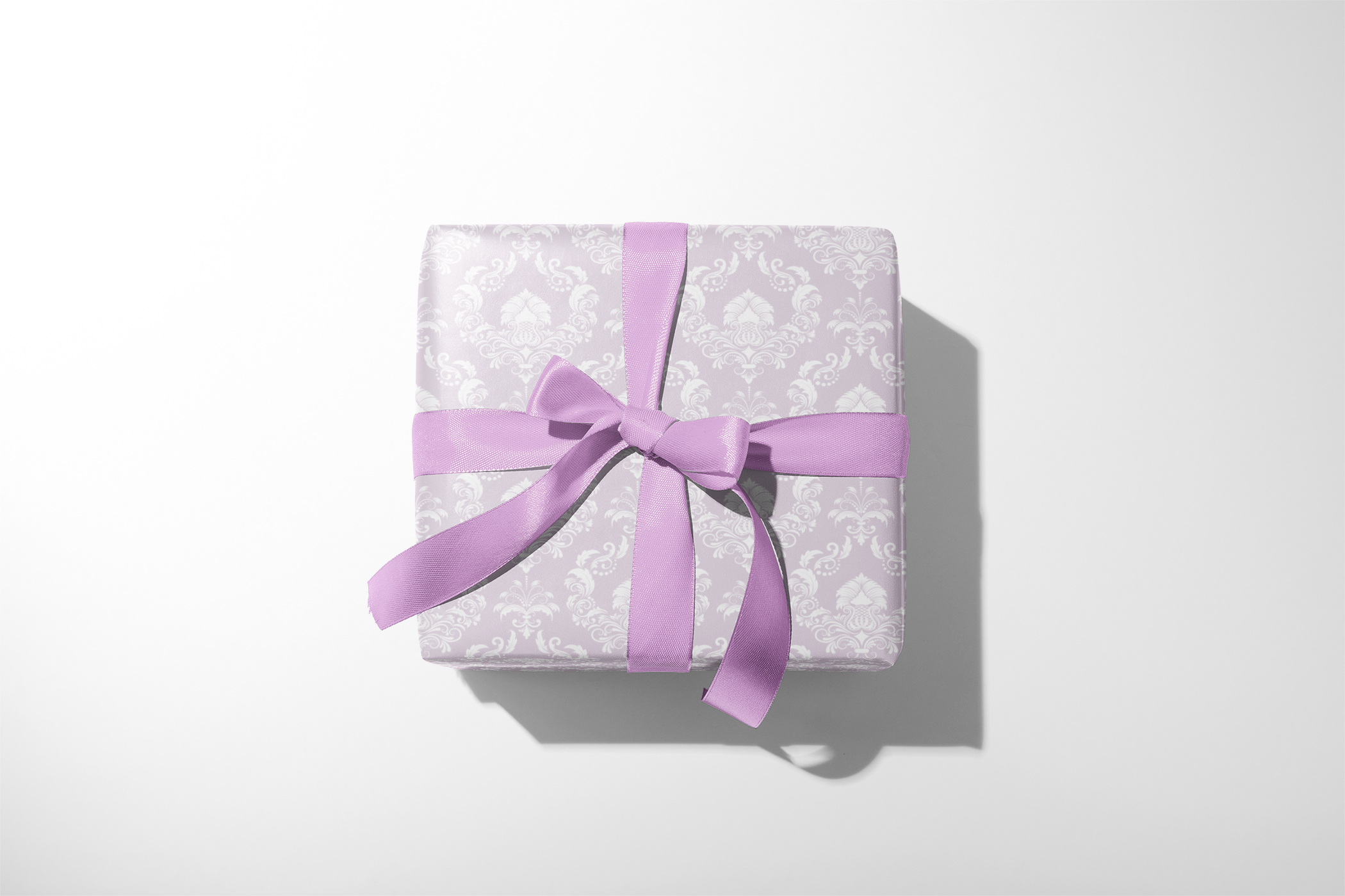 Alt Tag: Quiet Estate lavender damask wrapping paper gift wrap with white damask pattern and lavender ribbon bow