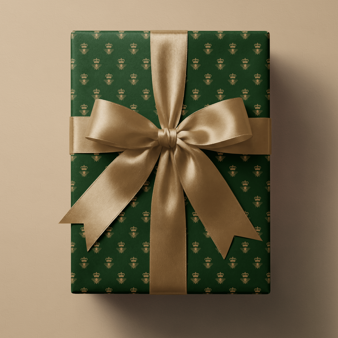 Green and Gold Wrapping Paper Emerald Monarch with metallic gold crowned bee pattern, wrapped gift box with satin gold ribbon bow