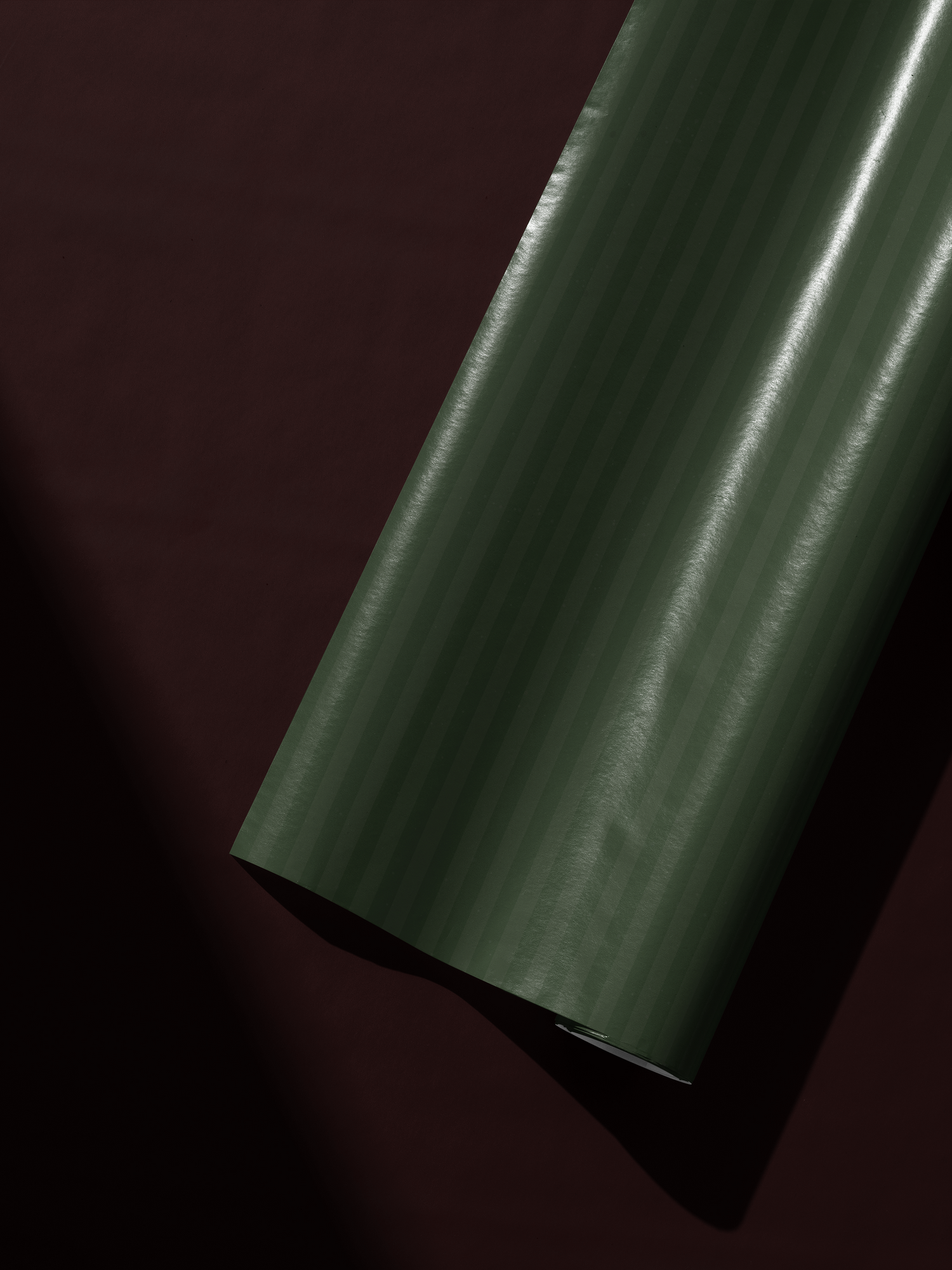 Alt Tag: Green Striped Wrapping Paper roll in deep forest and muted olive vertical stripes, Estate Stripe design