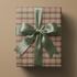 Neutral Plaid Wrapping Paper gift wrap in muted cranberry, sage, and cream tartan with sage satin ribbon bow