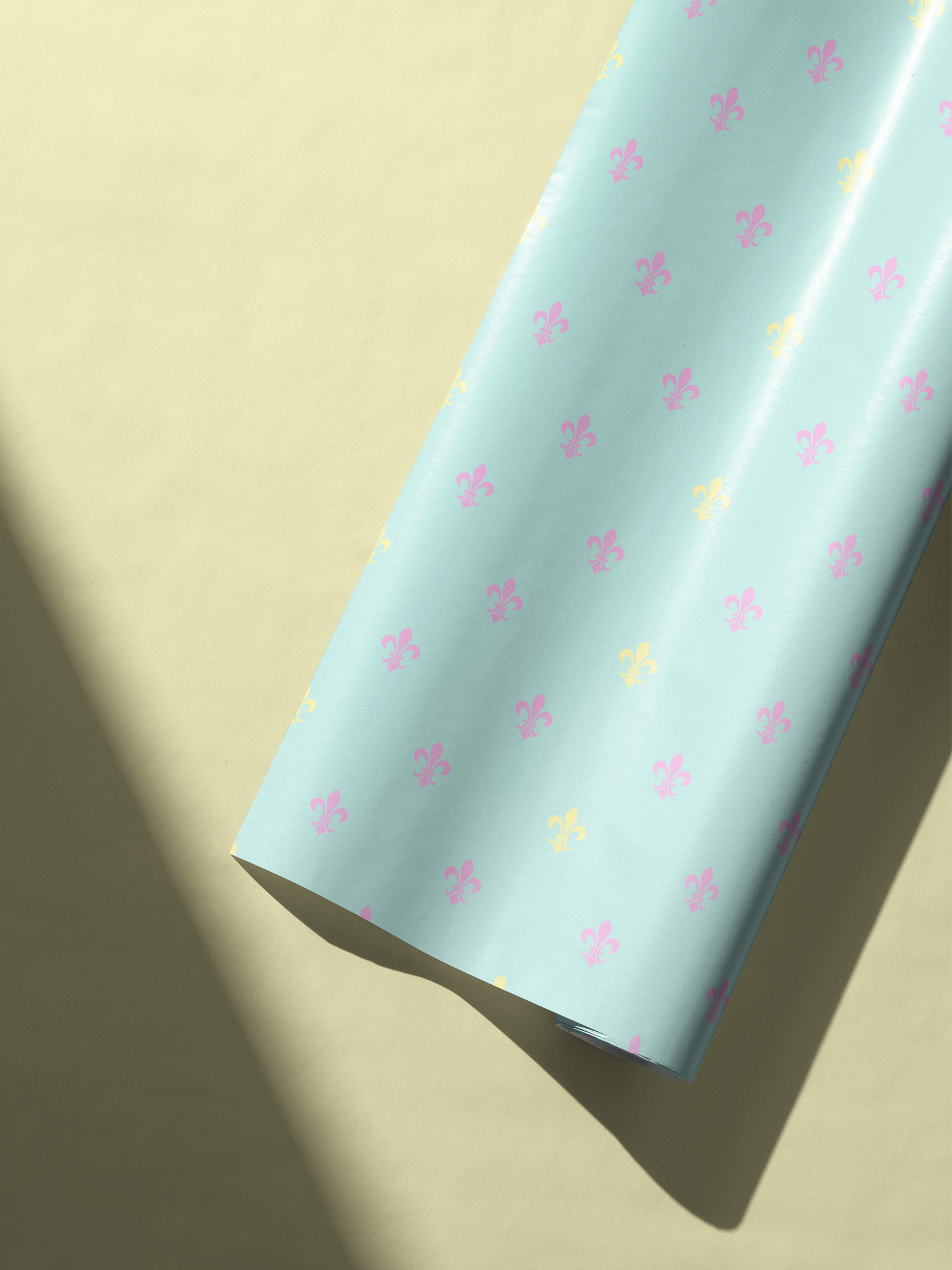 Alt Tag: Fleur de Lis Wrapping Paper in powder blue with pastel fleur-de-lis motifs in blush pink and buttery yellow