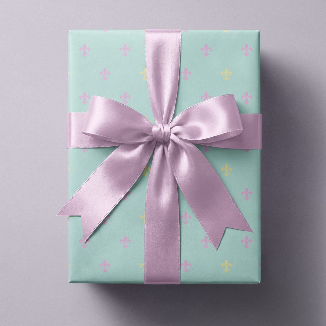 Alt Tag: Fleur de Lis Wrapping Paper on powder blue gift box with pastel fleur-de-lis pattern and lilac satin ribbon bow