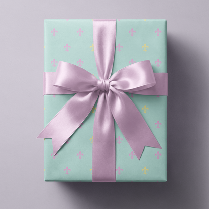 Alt Tag: Fleur de Lis Wrapping Paper on powder blue gift box with pastel fleur-de-lis pattern and lilac satin ribbon bow