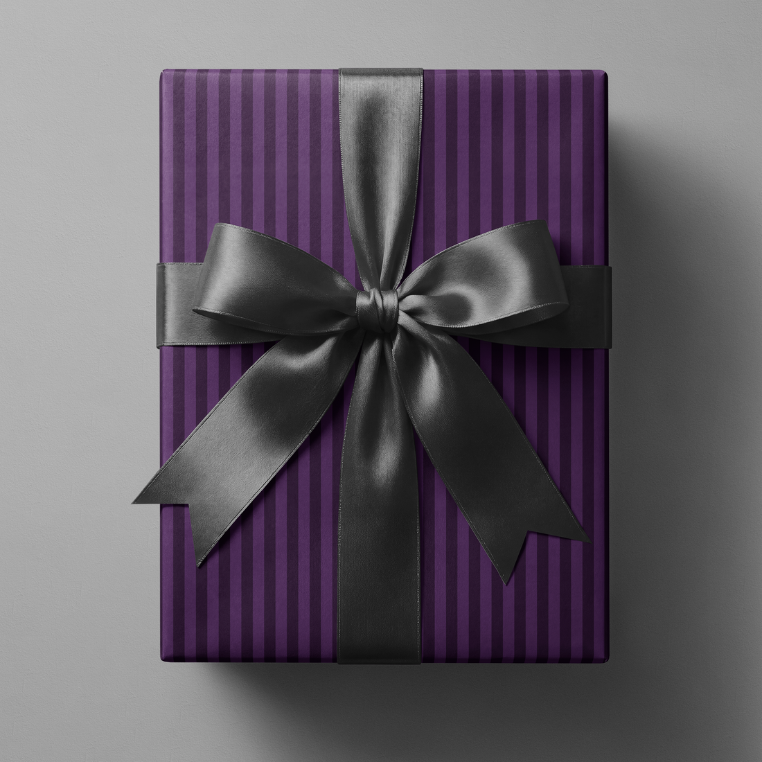 Purple Striped Wrapping Paper on gift box with rich violet vertical pinstripes and black satin ribbon bow