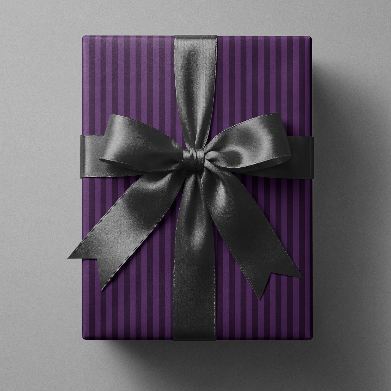 Purple Striped Wrapping Paper on gift box with rich violet vertical pinstripes and black satin ribbon bow