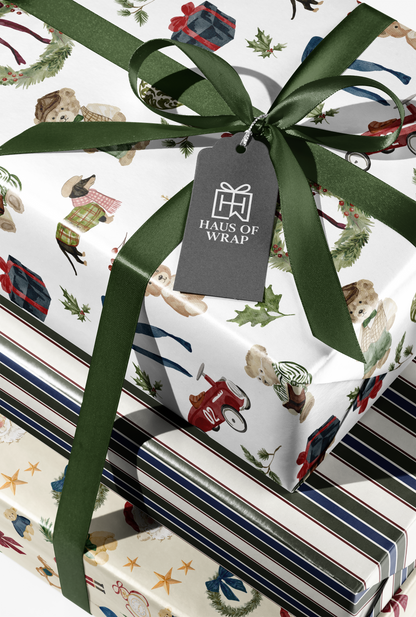 Alt Tag: Striped Wrapping Paper gift wrap with forest green ribbon bow and Haus of Wrap tag, stacked presents in classic heritage style